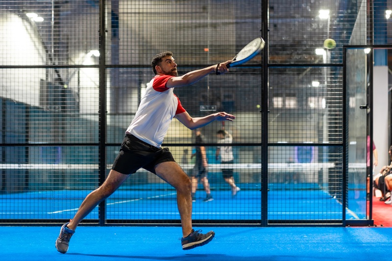 Padel player on an indoor court